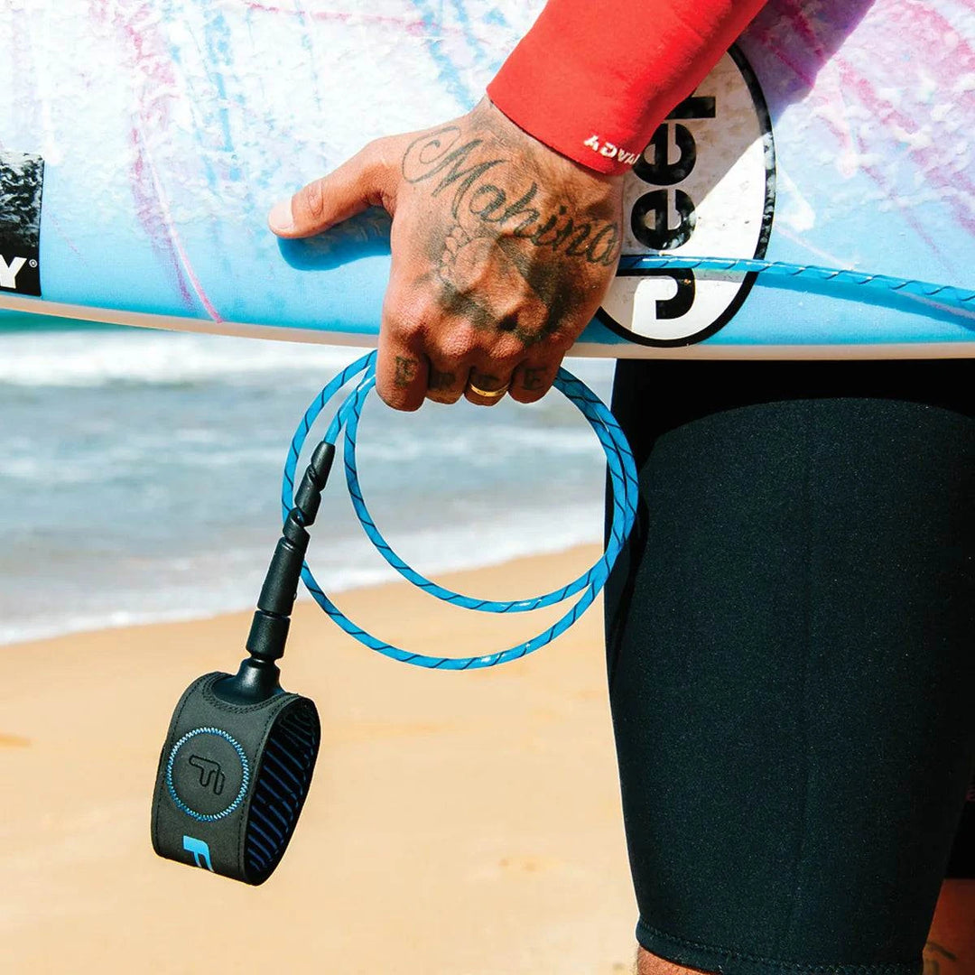 a man holding a surfboard with a blue rope attached to it