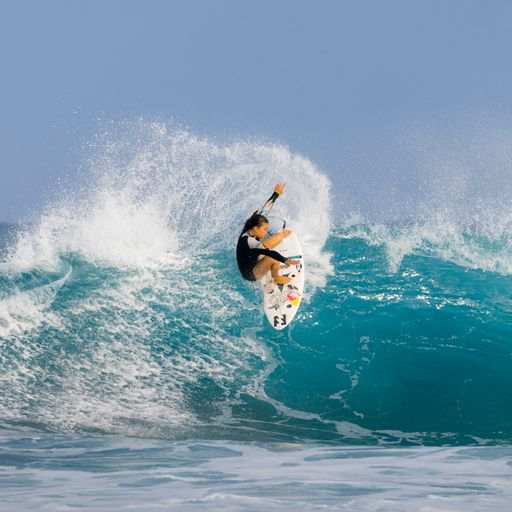 a man riding a wave on top of a surfboard