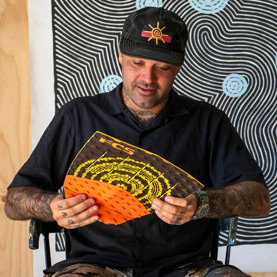 a man sitting in a chair holding a piece of paper