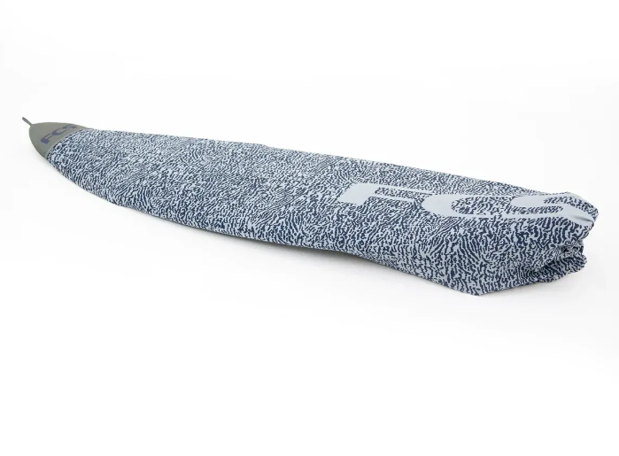 a surfboard covered in a towel on a white background